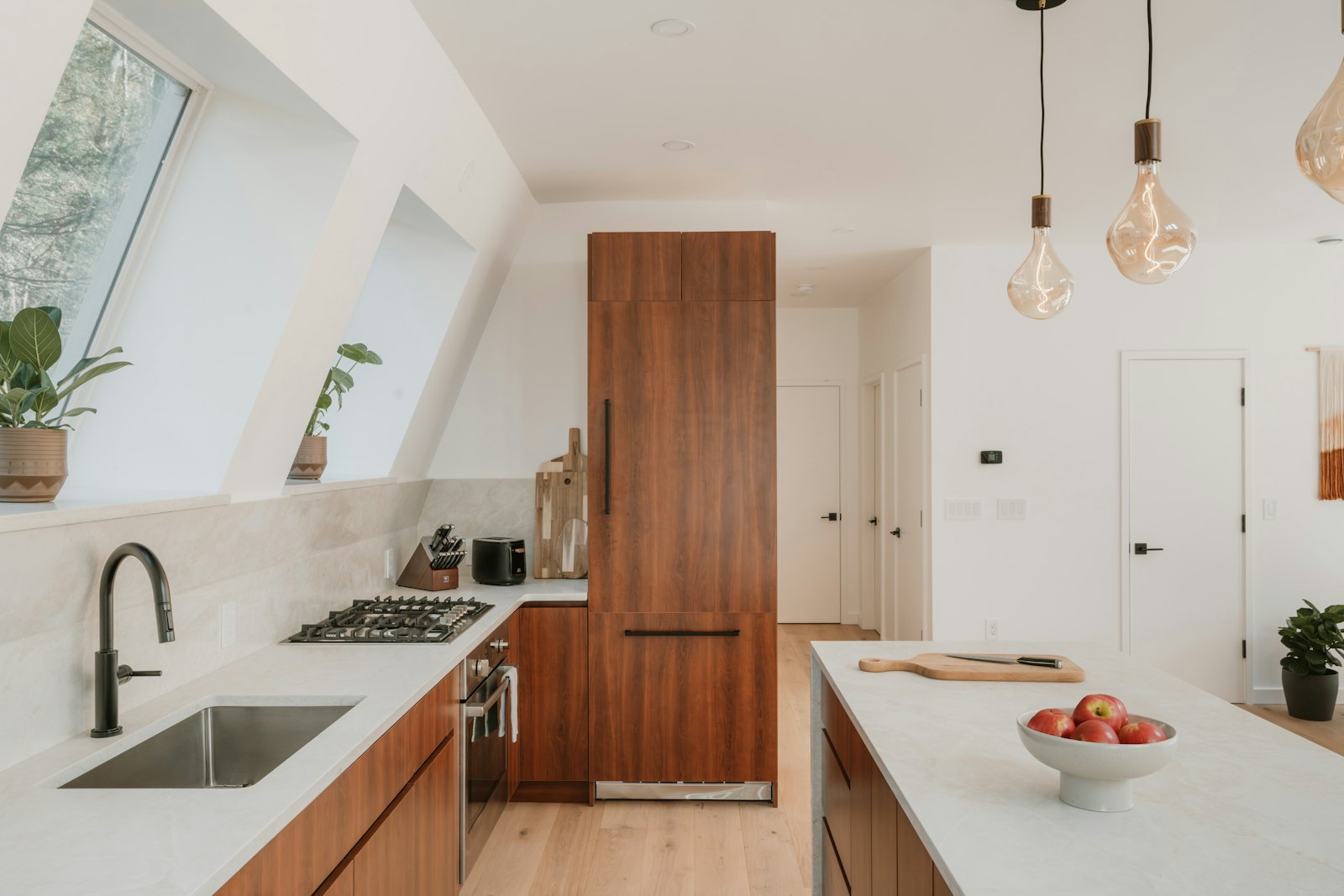 Renovated kitchen with walnut cabinetry and quartz benchtops
