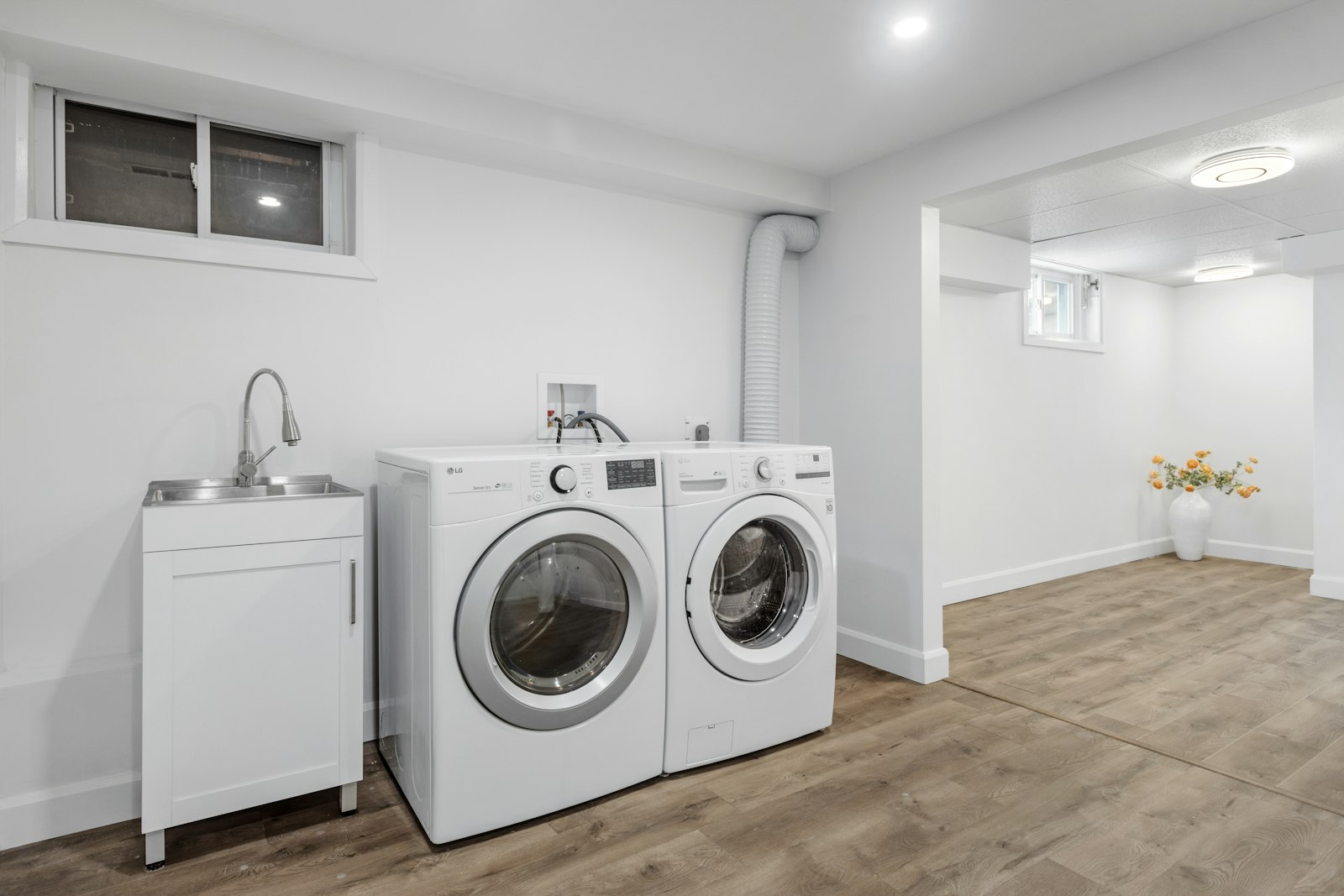 Spacious laundry with dedicated sink and bench space
